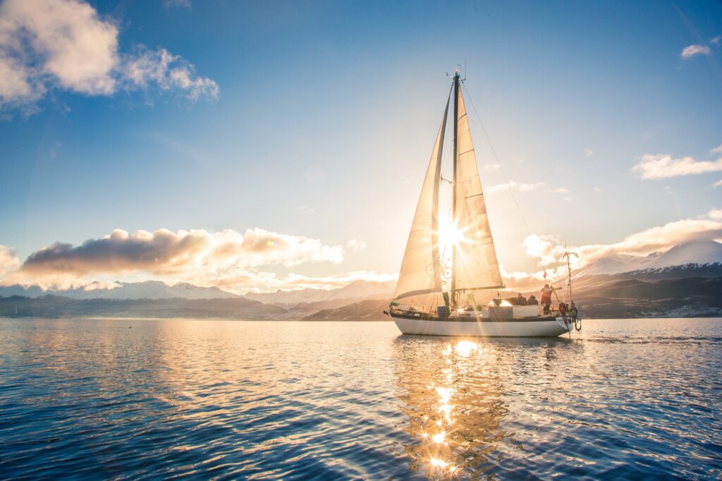 Sailboat in sea on background of mountains